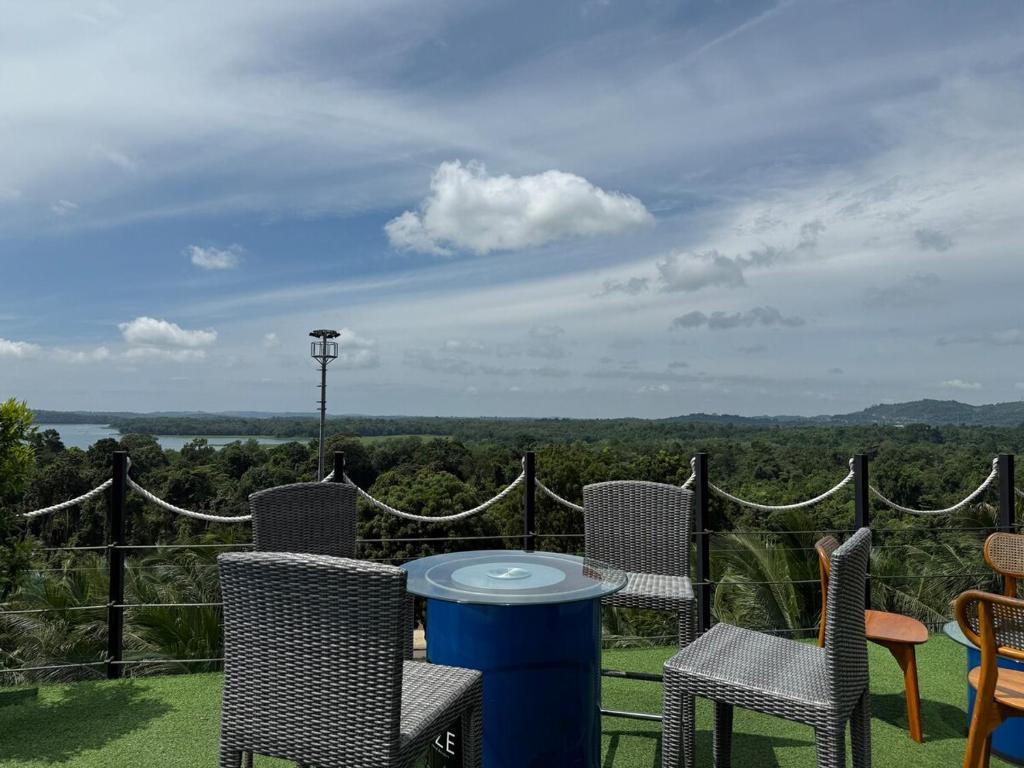 a patio with chairs and a table with a view at Panbil Residence Apartment Lvl 15 with Forest View in Kangboi