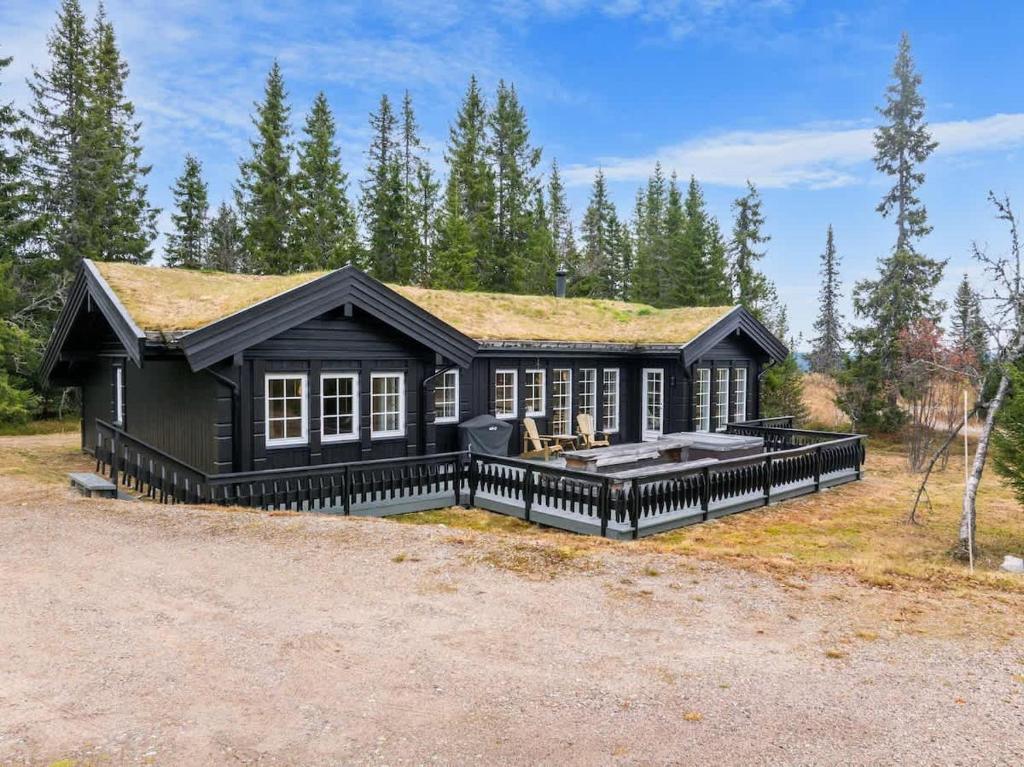 a black house with a grass roof at Fagerasen 303 by Vacation Trysil in Mælem