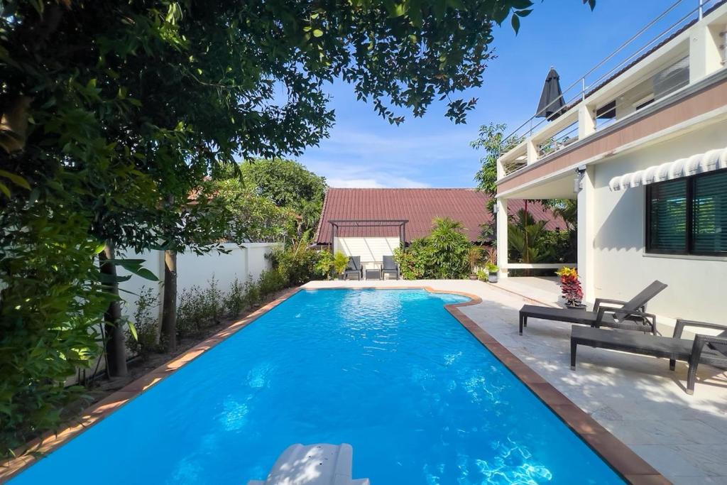 a swimming pool in the backyard of a house at Charming 3BR villa with Private pool in Bangrak Beach