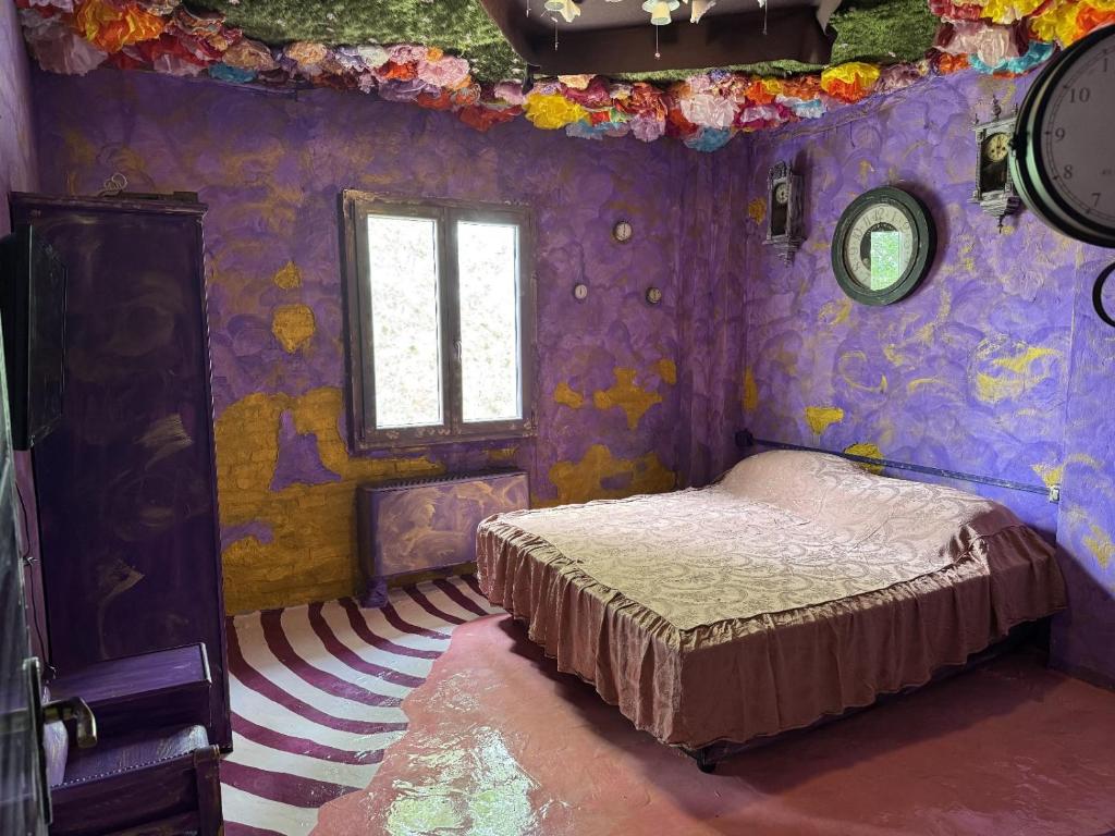 a bedroom with a bed in a purple room at Paciu Maison in Ozzano dell Emilia
