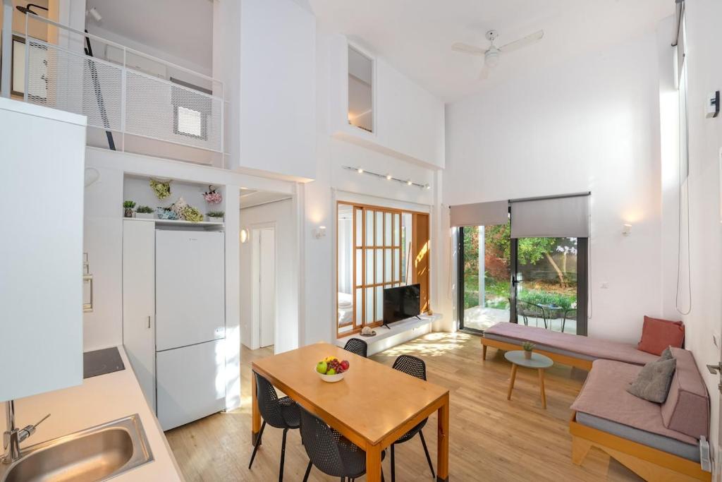 a kitchen and living room with a table and a couch at Central cozy garden flat in Mesochórion
