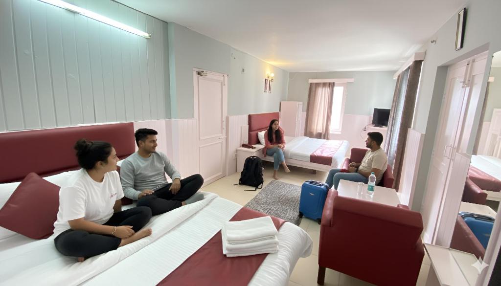 a group of people sitting in a room at Hotel Sunrise Meadows Mountain in Manāli
