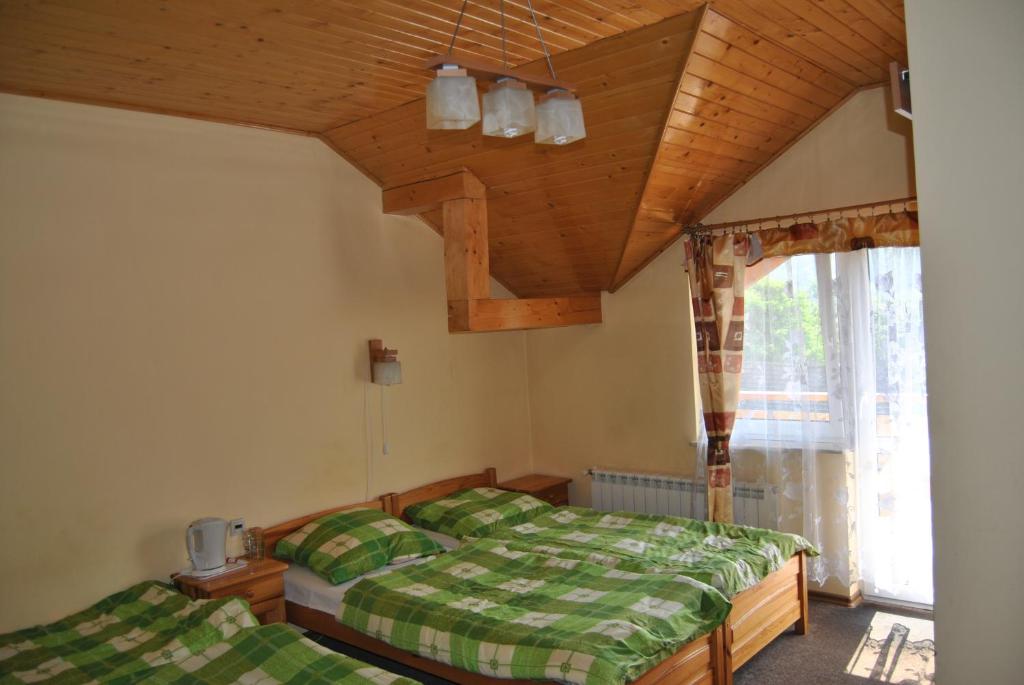 Postel nebo postele na pokoji v ubytování Willa pod Pilskiem