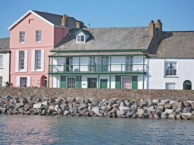 a large house on the shore of a body of water at Waters Edge in Instow