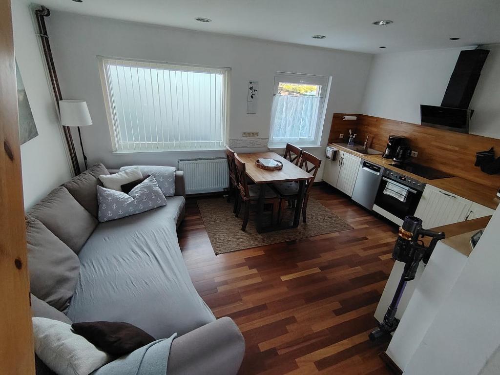 a living room with a couch and a table at Ferienhaus An der Brunnenaue in Stralsund