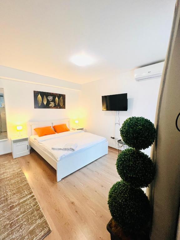 Ένα ή περισσότερα κρεβάτια σε δωμάτιο στο Airport Gardens Studio