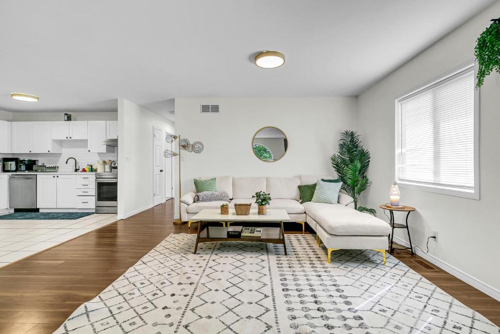 a living room with a couch and a table at Bright and chic home with a cozy touch in Windsor