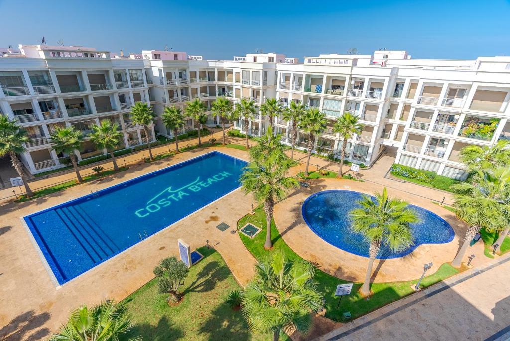 an aerial view of a large apartment complex with a swimming pool at Spacious luxury apartment with pool in Bouznika