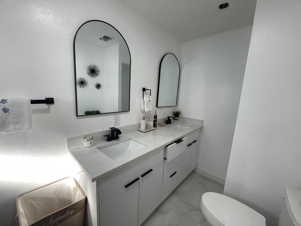 a white bathroom with a sink and a mirror at My Relaxing place! in North Fort Myers