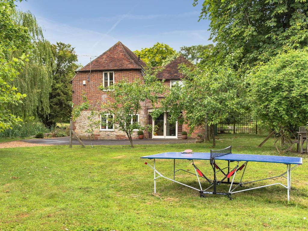 a ping pong table in front of a house at Kingfisher Oast in Hollingbourne