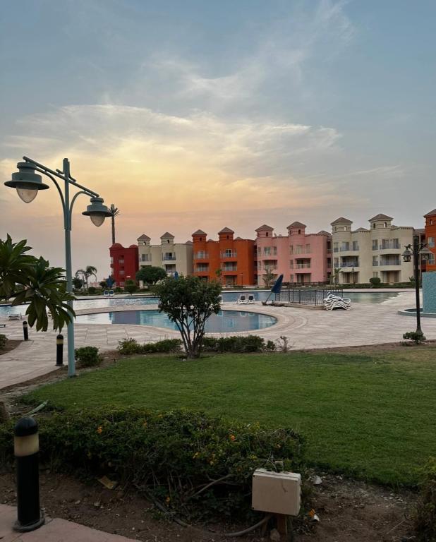- une piscine dans un parc avec des immeubles d'appartements dans l'établissement Amer Group Villas and Chalets on the Pool, à Ain Sokhna