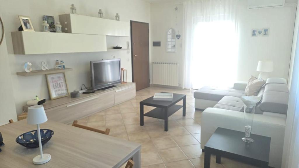 a living room with a couch and a tv at Casa Adelaide - A stone's throw from Rome in Gavignano