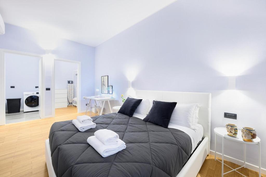 a bedroom with a large bed with two towels on it at Suite Andrea-Luxury Central Suite in Bergamo