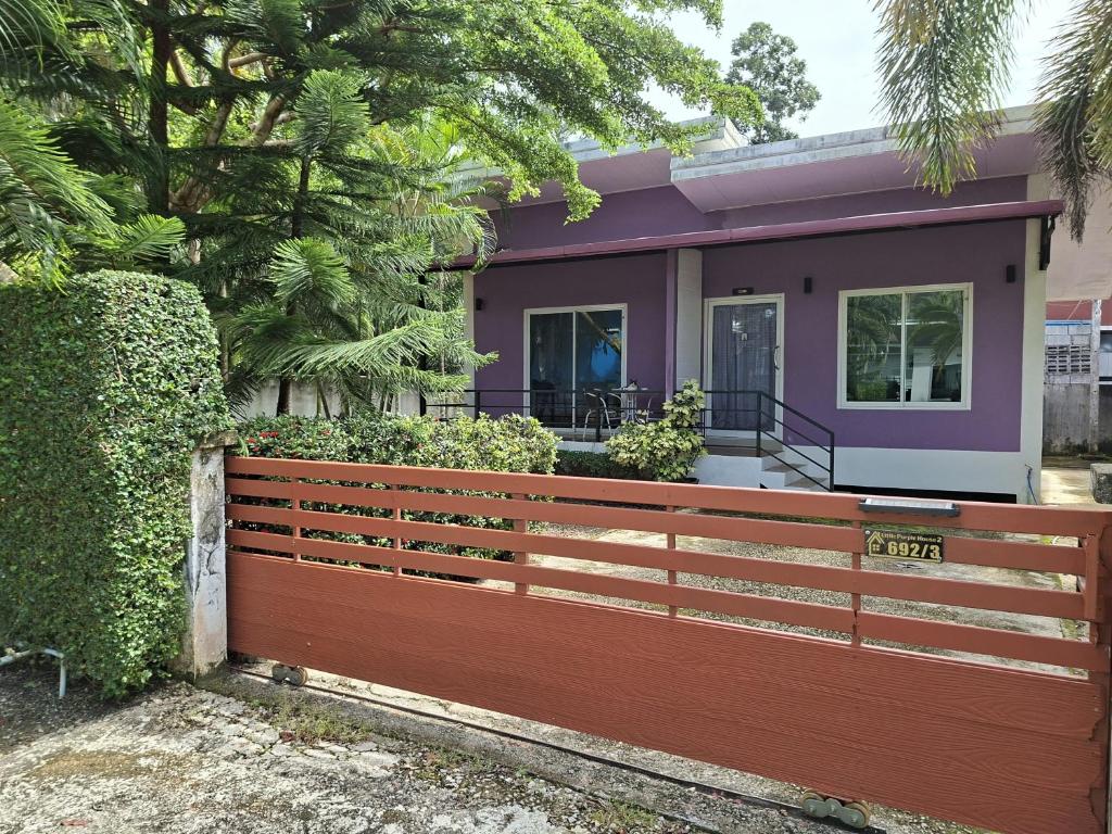a house with a wooden fence in front of it at Little Purple House 2- AoNang in Ao Nang 
