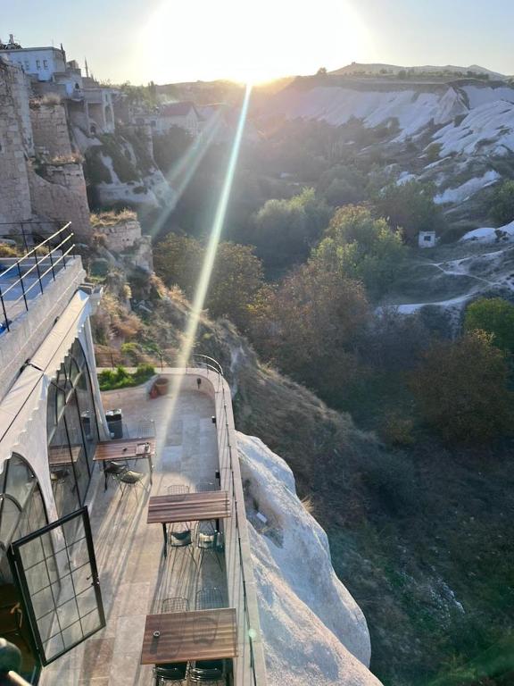 an observation deck with benches on top of a mountain at Valinor Cappadocia in Ürgüp