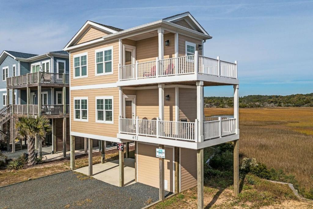 a large house with balconies on the side of it at Second Row Stunning Ocean and Marsh Views in Holden Beach