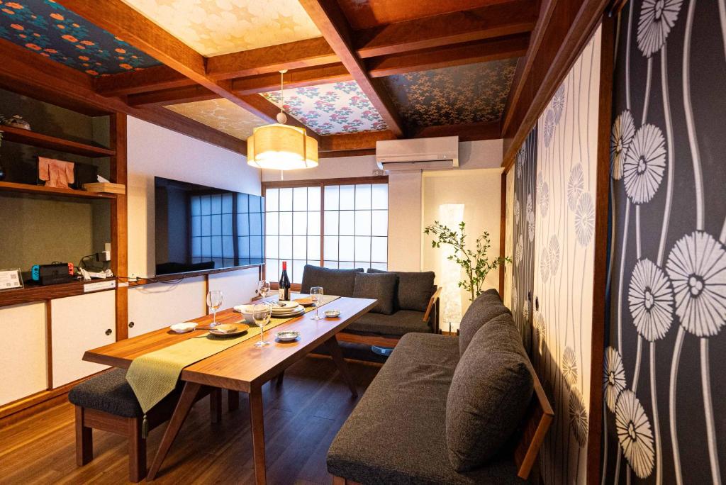 a living room with a table and a couch at MOMOYA tsudoi in Okayama