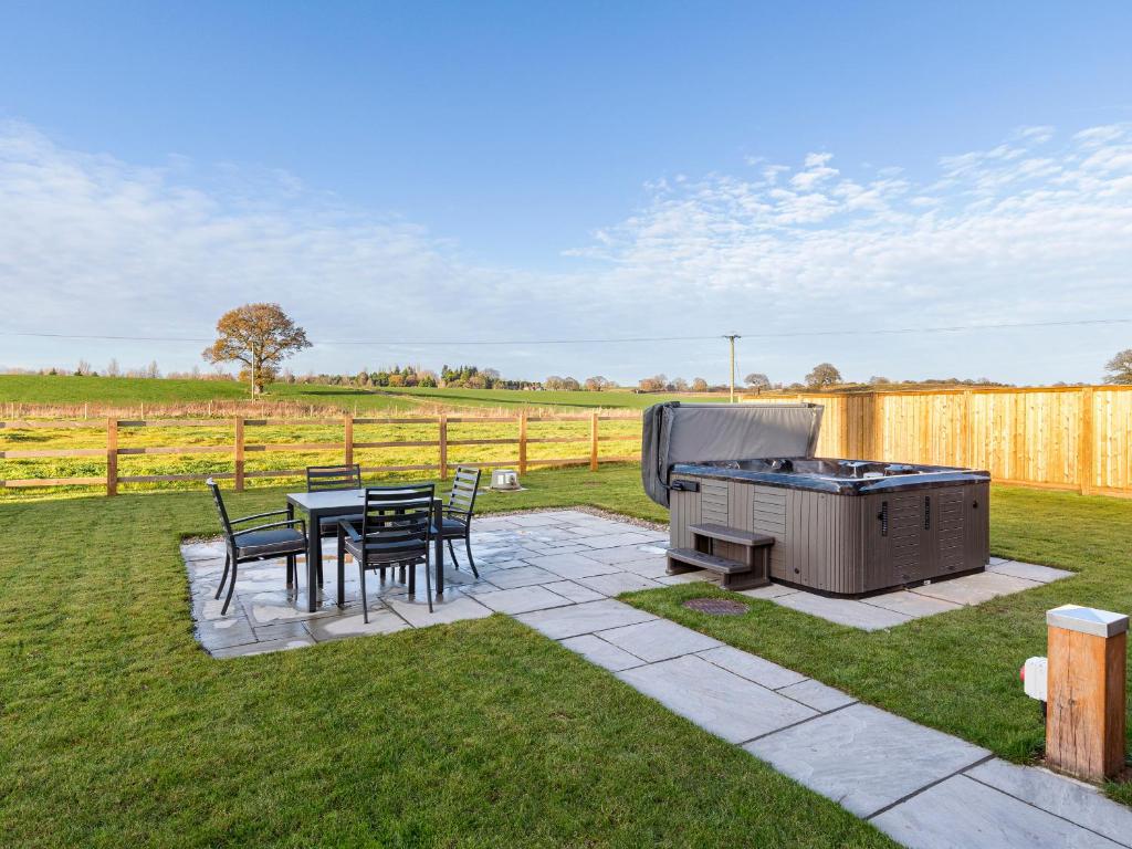 a backyard with a grill and a table and chairs at The Foundary - Uk36319 in Whitchurch