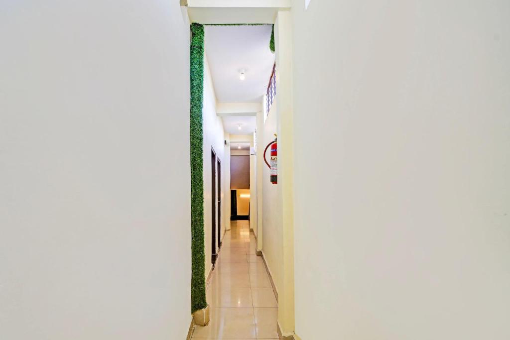 a hallway of a hotel with white walls at Super Hotel O York Residency in Bhopal
