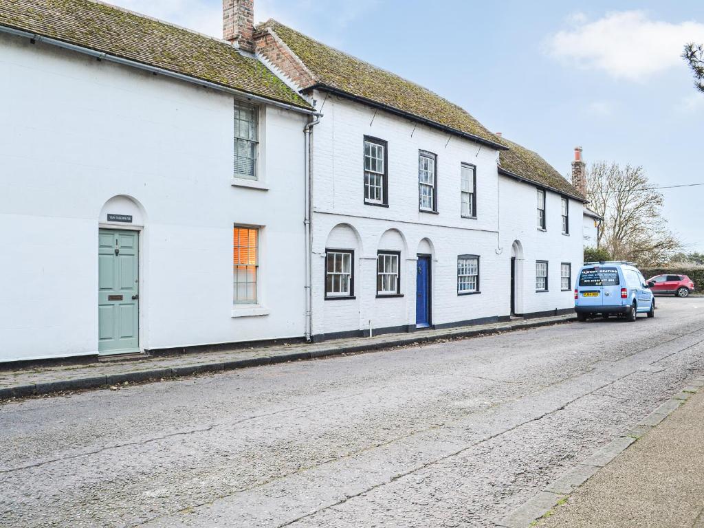 a row of white houses on a street at Yew Tree House Cottage in New Romney