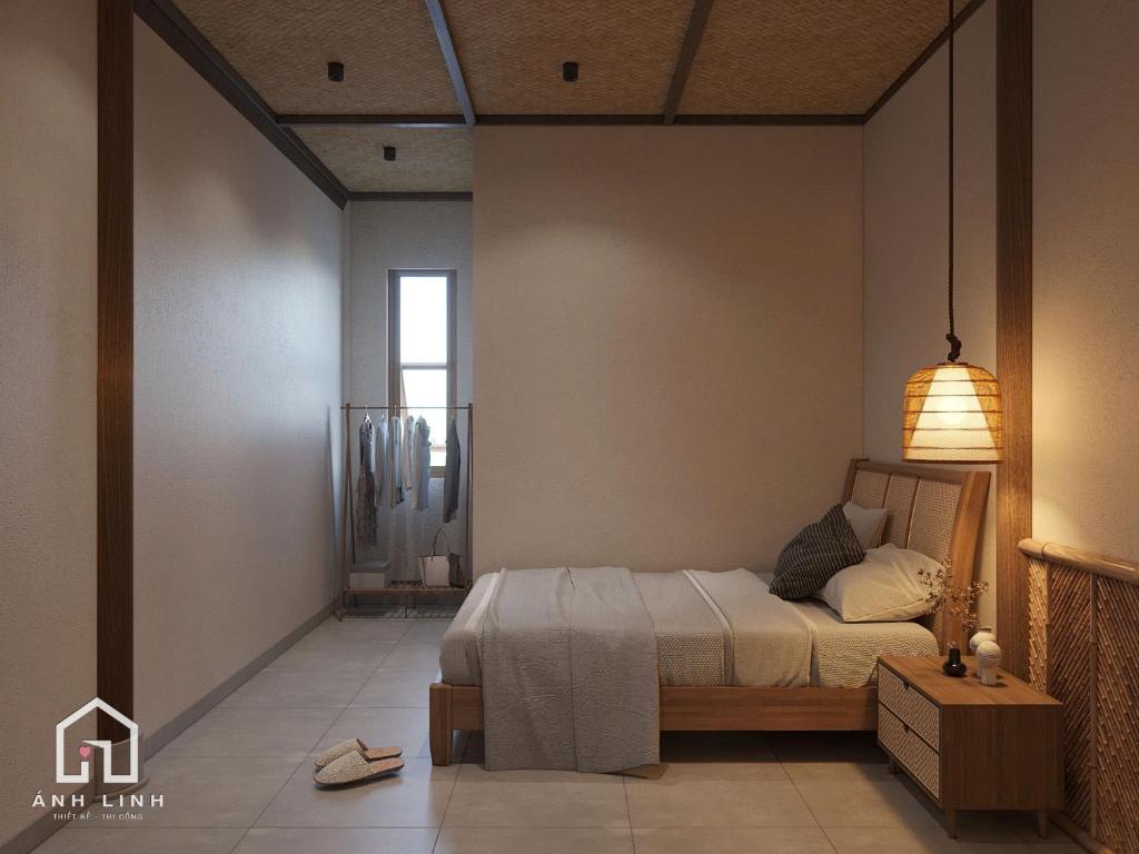 a bedroom with a bed and a lamp in it at Du già ecolodge in Yên Minh