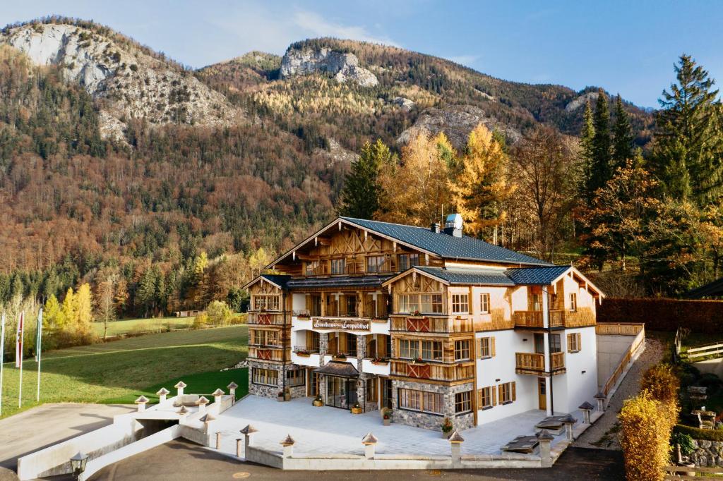 an aerial view of a house with mountains in the background at Landhaus Leopoldhof in St. Wolfgang