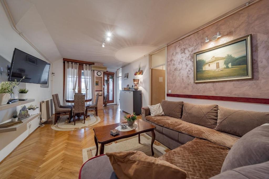 a living room with a couch and a table at Ada Home Belgrade Apartment 