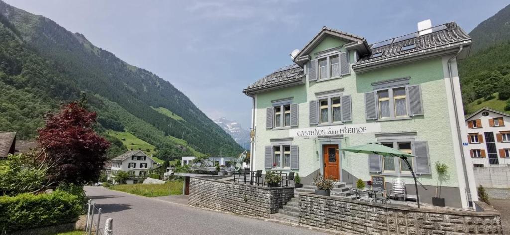 a building on a street with a mountain at Gasthaus zum Freihof in Engi
