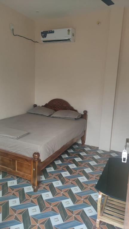 a bedroom with a bed with a geometric floor at ACS New Cottage in Thiruchendur