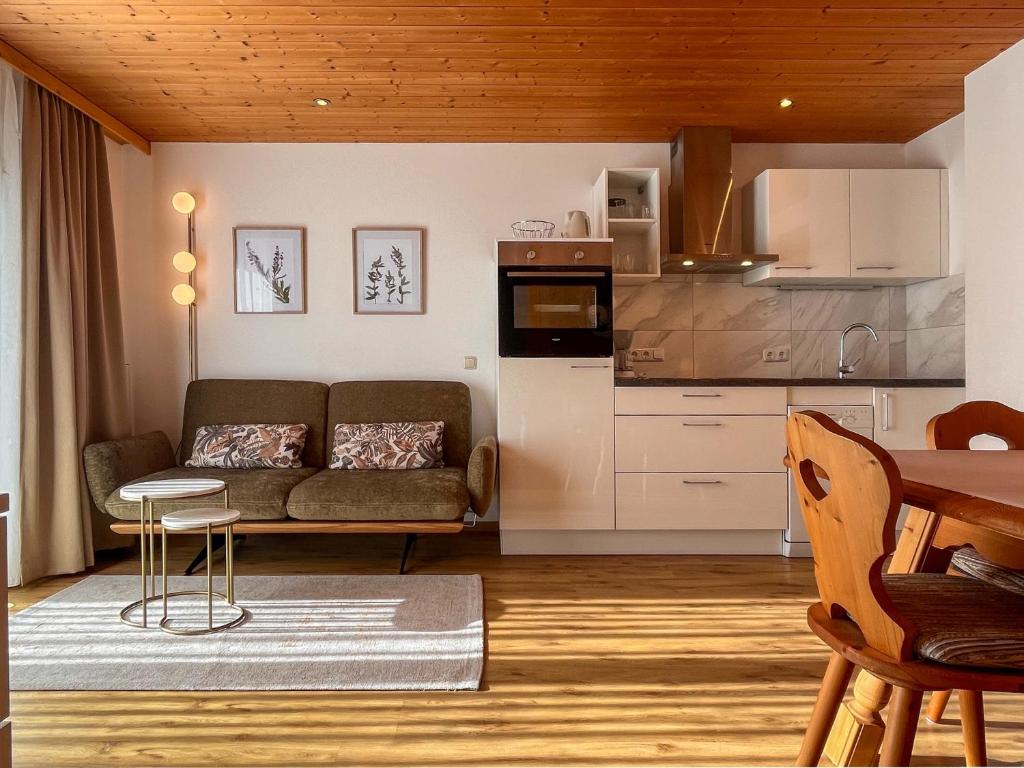 a living room with a couch and a kitchen at Haus Bianca in Gaschurn