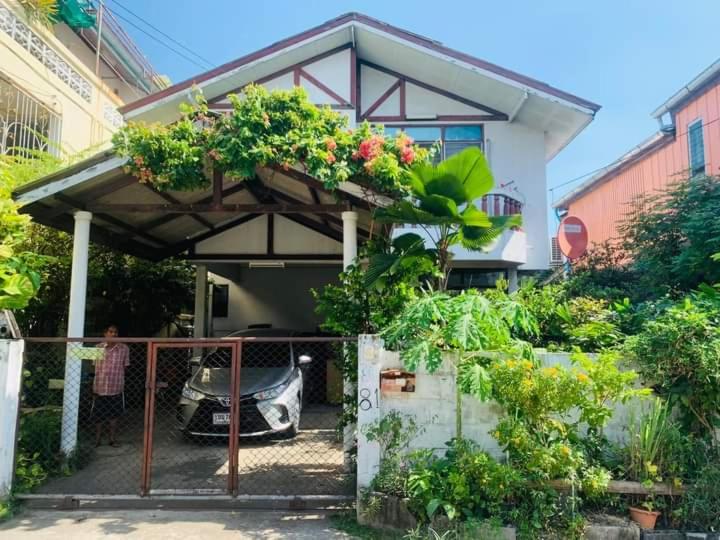a house with a car parked in front of it at Palmhouse studio room in Bang Khen