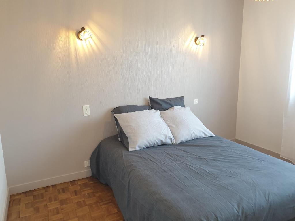 a bedroom with a bed with two pillows on it at Logis Coeur de Bretagne in Bieuzy-les Eaux