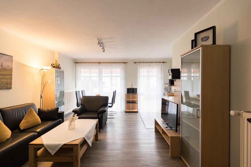 a living room with a couch and a table at Mayglück App 1 in Norderney