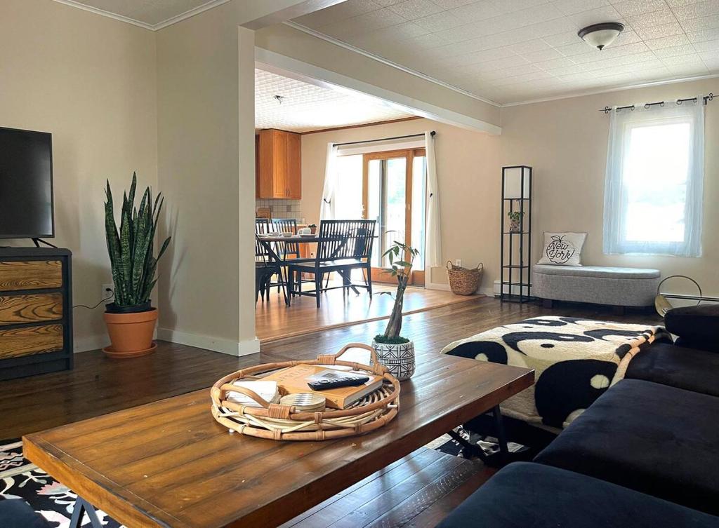 a living room with a couch and a table at Cozy Creek House in Forestburgh