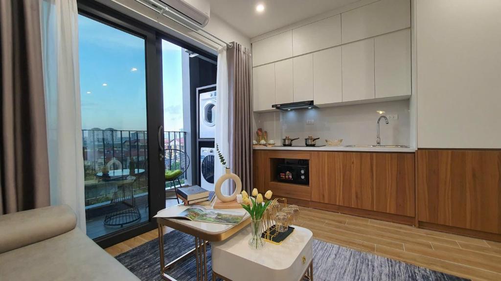 a kitchen with a table and a large window at The West Lake Serenity'N Homestay Ha Noi 462 in Hanoi