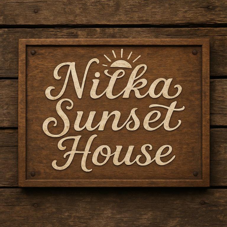 a sign for a nilla sunset house on a wooden wall at Nilka sunset house in Colón