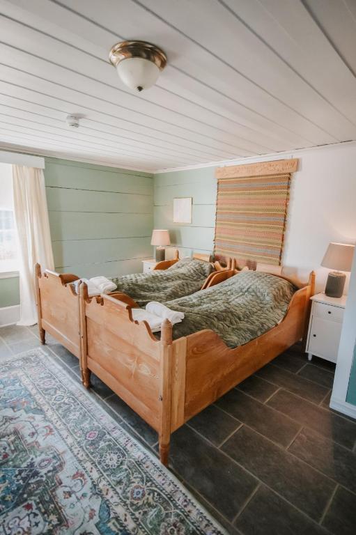 a bedroom with a large wooden bed in a room at Helgaker Gård in Gran