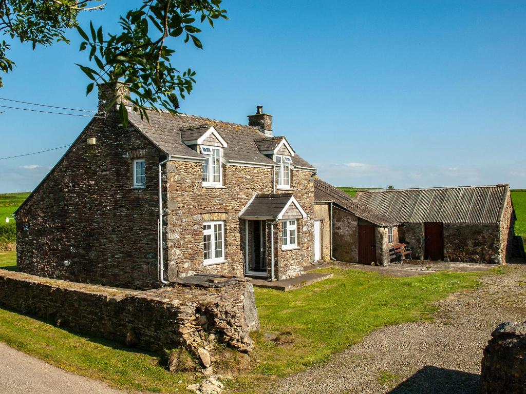 an old stone house with a roof at The Bickney in Llanrian