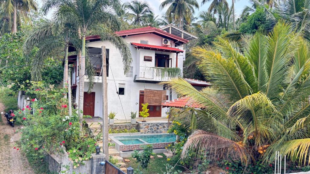 a house with a swimming pool in front of it at Brown Birds Villa in Tangalle