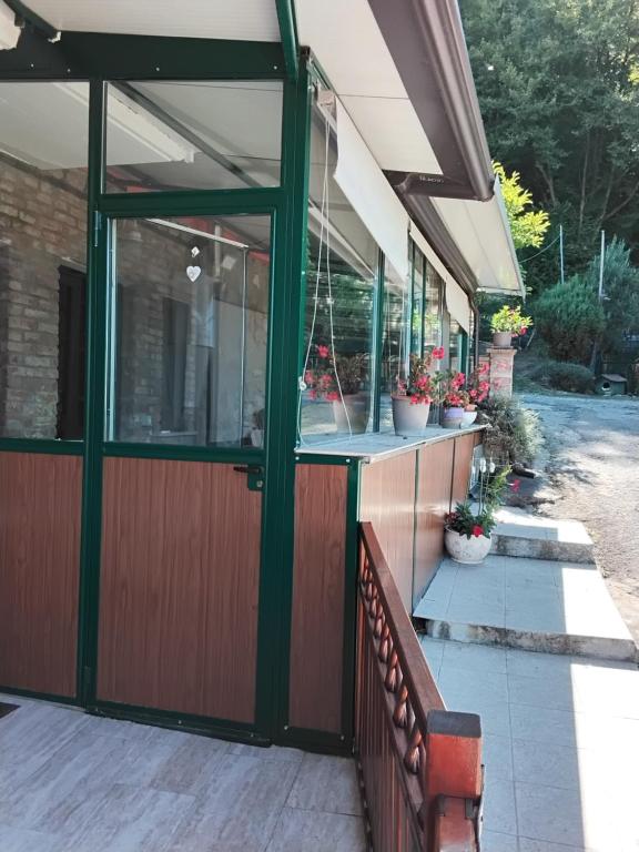 a porch with a glass door and a bench at Oasi di pace in Rocca deʼGiorgi