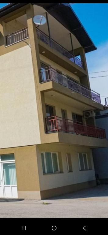a tall building with balconies on the side of it at Sunshine Apartments Visoko in Visoko