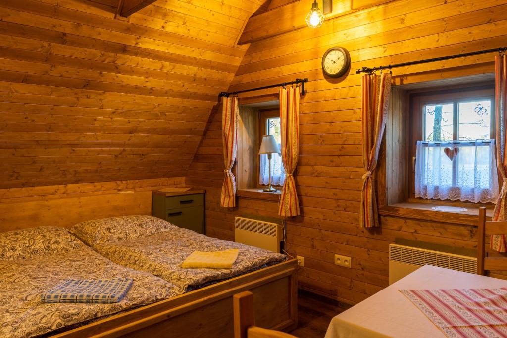 a bedroom with a bed and a clock on the wall at U Kováře Matěje in Dřevíkov