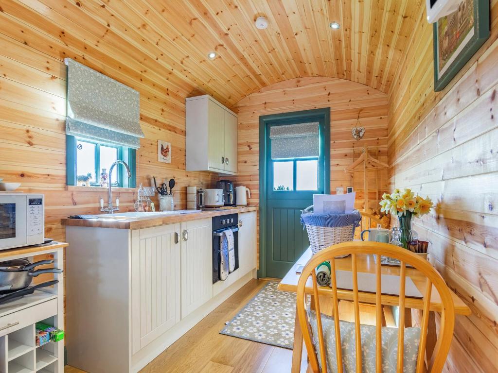 a kitchen with wooden walls and a wooden ceiling at Cater Tober Haven in Dunnet