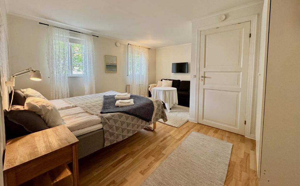 a bedroom with a bed and a living room at Strandlogiet Ljugarn in Ljugarn