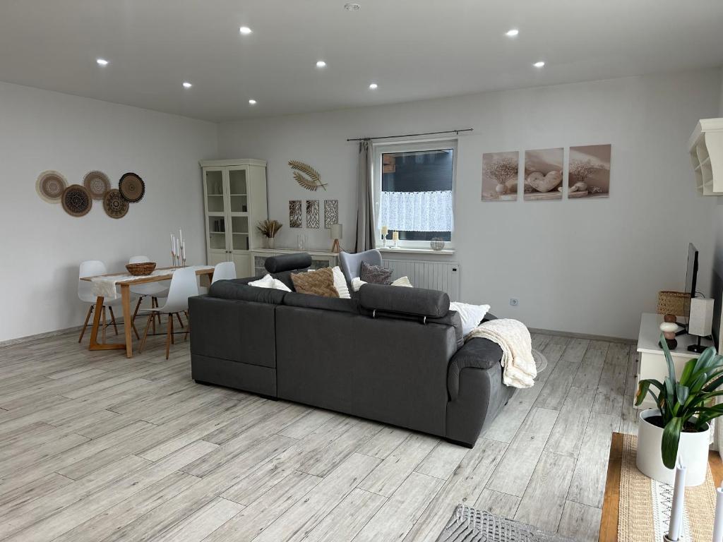 a living room with a couch and a table at SleepShop in Nordhausen