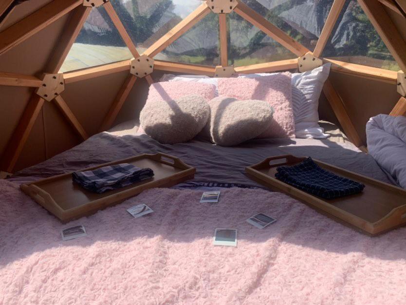 a bed in a tent with a tray on it at Dôme étoilé in Pléneuf-Val-André