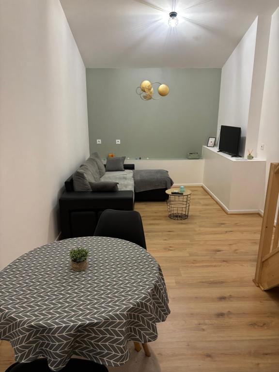 a living room with a table and a couch at L escapade pro in La Roche-Chalais