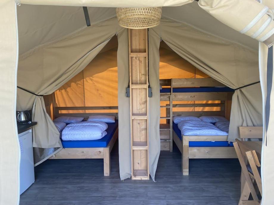 two beds in a tent in a room at Oh! Campings - Medrose Camping Ardèche in Saint-Thomé