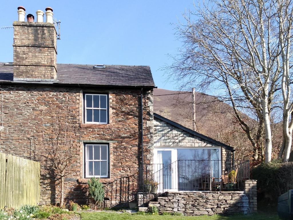 an old brick house with a chimney on top at Cropple Howe in Threlkeld