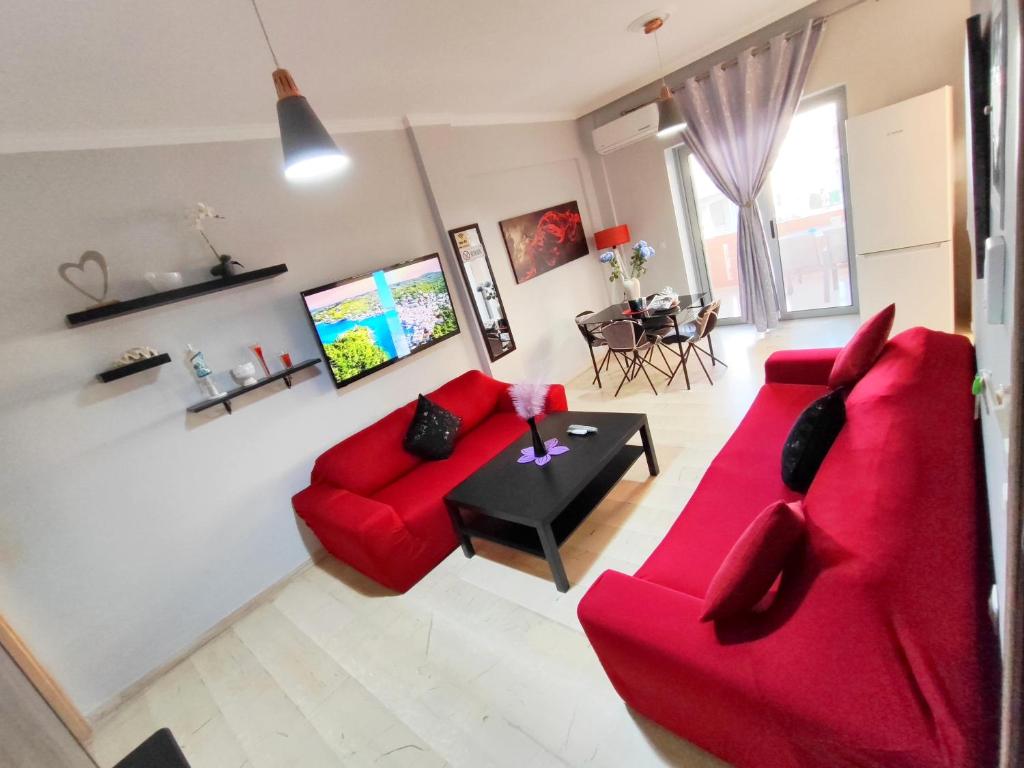 a living room with a red couch and a table at Marlen House Chania in Chania